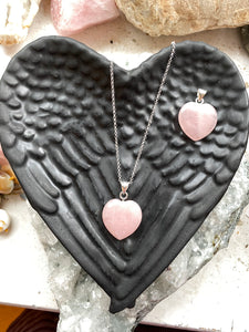 Rose Quartz Silver Heart Necklace on Shungite  stone background.