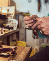 jewellery maker Carole behind the scenes in her brixton jewellery shop and workshop adorned in her own statement rings 