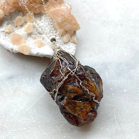 Natural Black Amber from Mexico. Sterling  Silver wire and chain. Side view. Hand Crafted by Full Moon Designs, London.