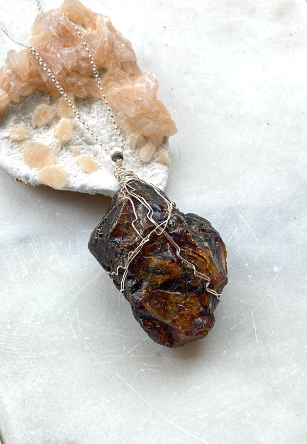 Natural Black Amber from Mexico. Sterling  Silver wire and chain. Side view. Hand Crafted by Full Moon Designs, London.