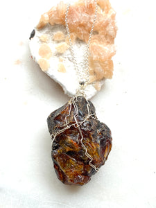 Natural Black Amber from Mexico. Sterling  Silver wire and chain. Side view. Hand Crafted by Full Moon Designs, London.