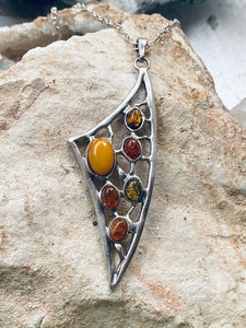 unusual Bespoke necklace. Sterling Silver with  amber of yellow, brown and green colour. By Full Moon Designs.